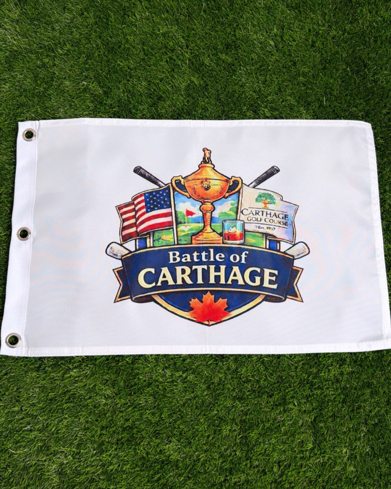 White flag with 'Battle of Carthage' logo on a green grass background
