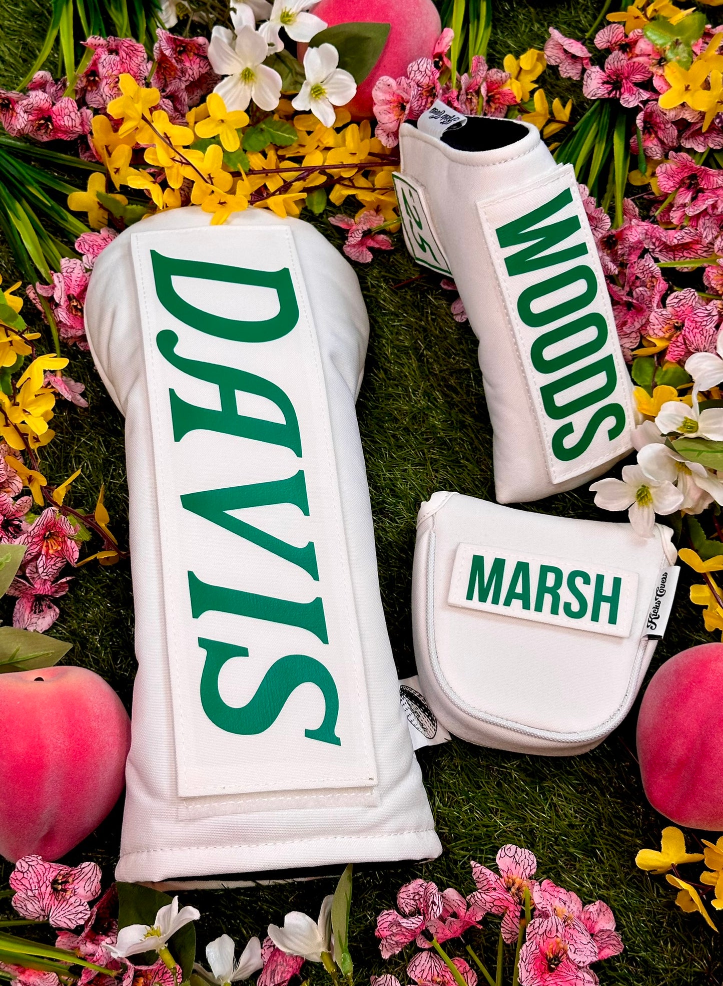 White golf club covers with 'DAVIS', 'WOODS', and 'MARSH' branding on a floral background.