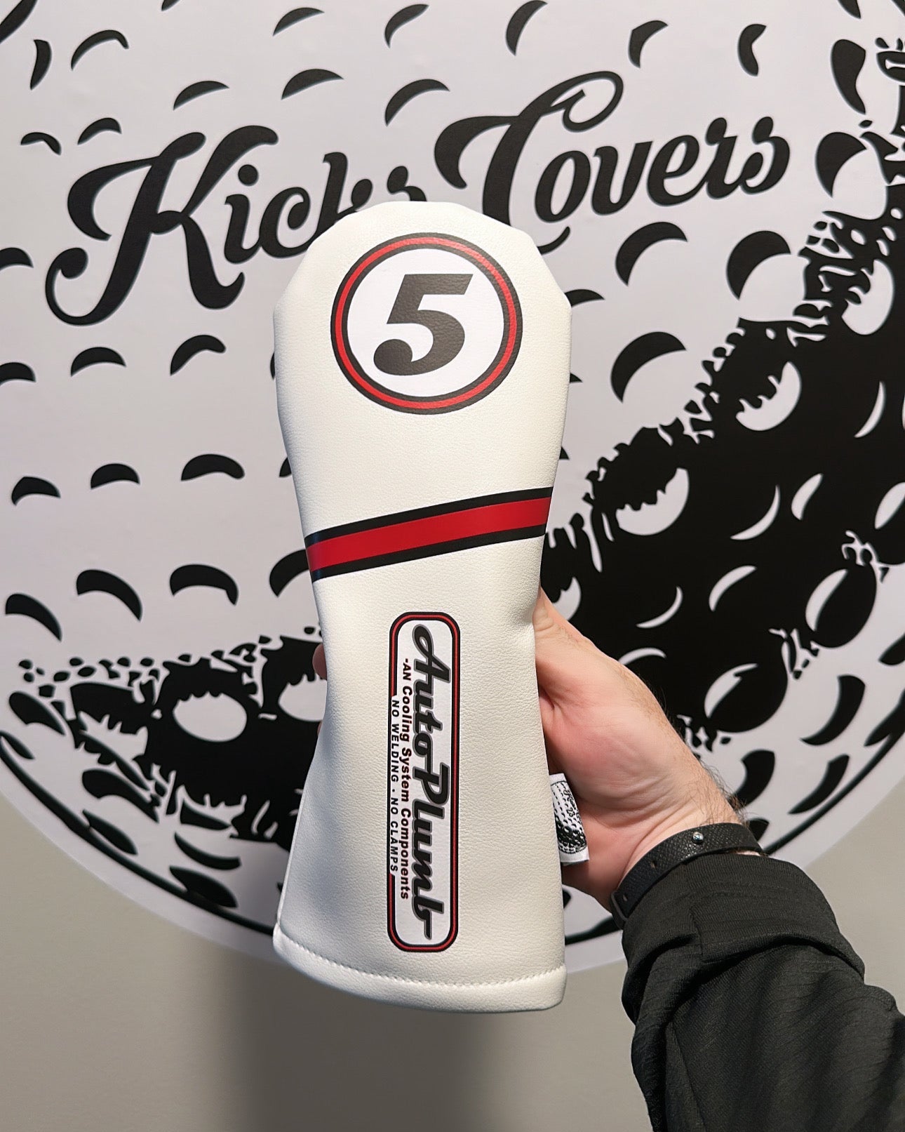 White golf club head cover with number 5 held in front of a 'Kicks Covers logo.